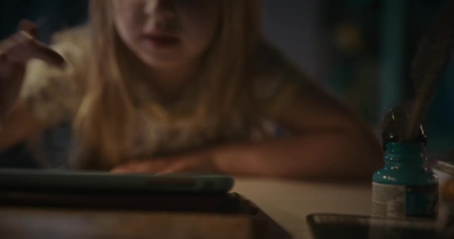 Girl tapping and clicking on her tablet