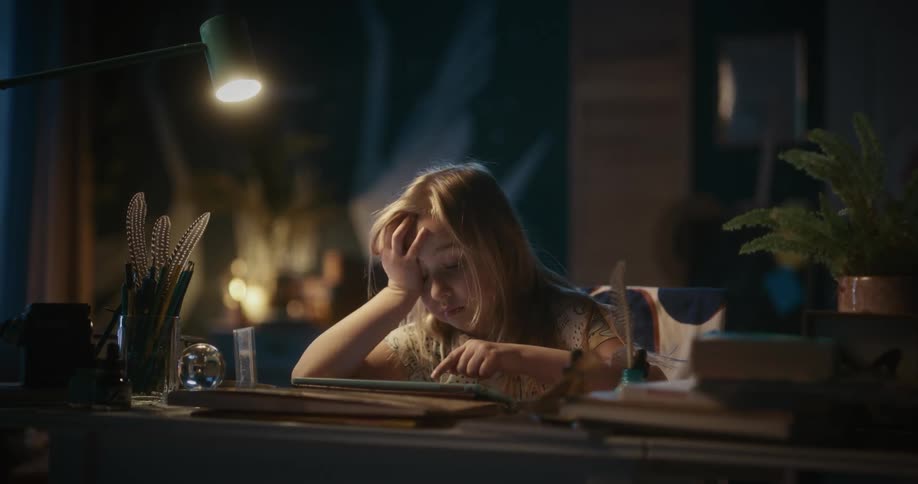 A girl watching videos on a tablet