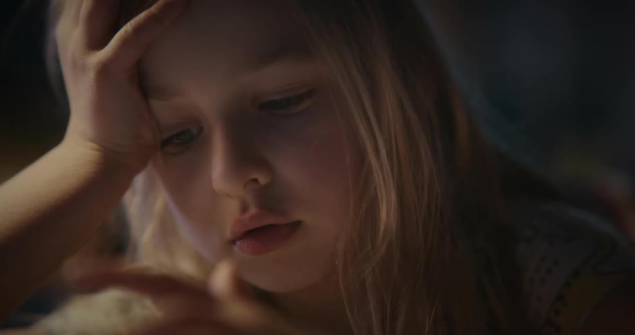 Close up of a blonde girl using a tablet