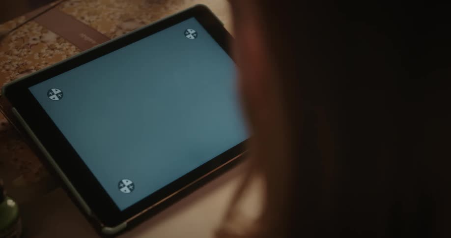 Female swipes and makes selections on tablet