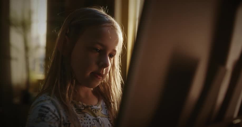 A girl is painting at home
