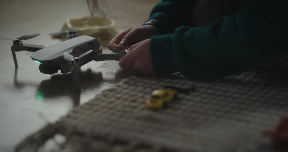 Child threading a sewing thread through a drone