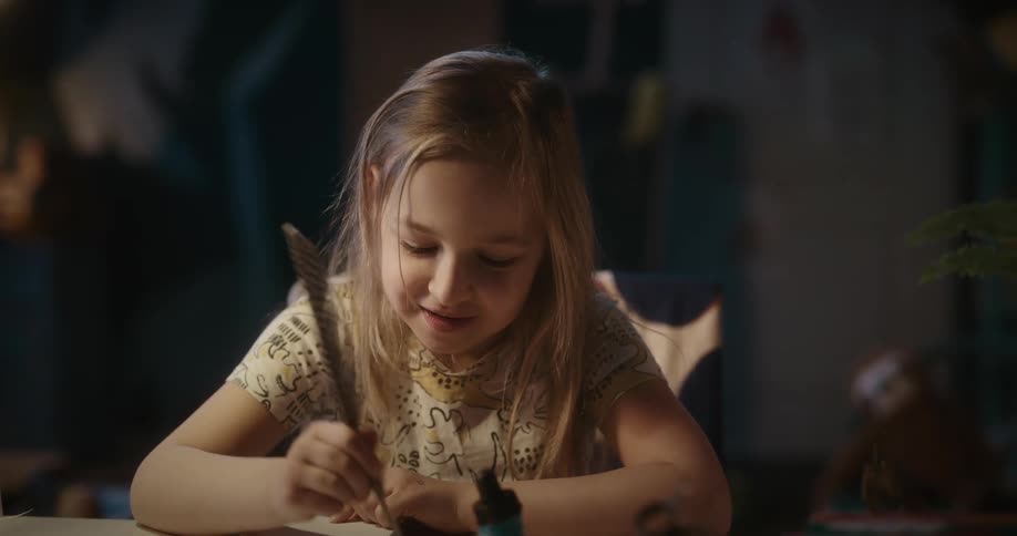 Girl drawing with a pen with ink
