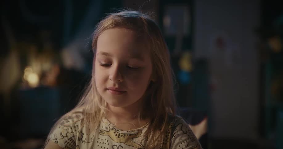 Girl sitting putting her hands on her head and dancing happily