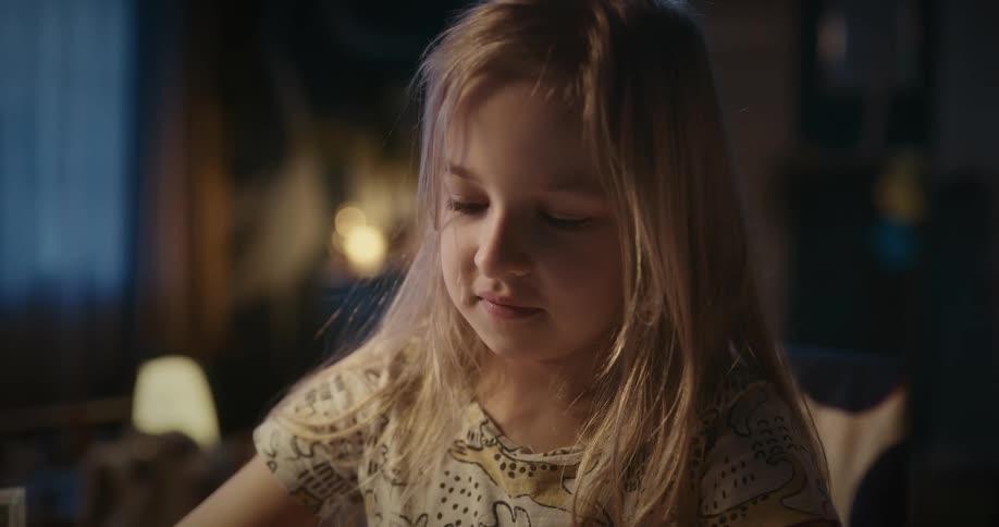 A girl is drawing at home
