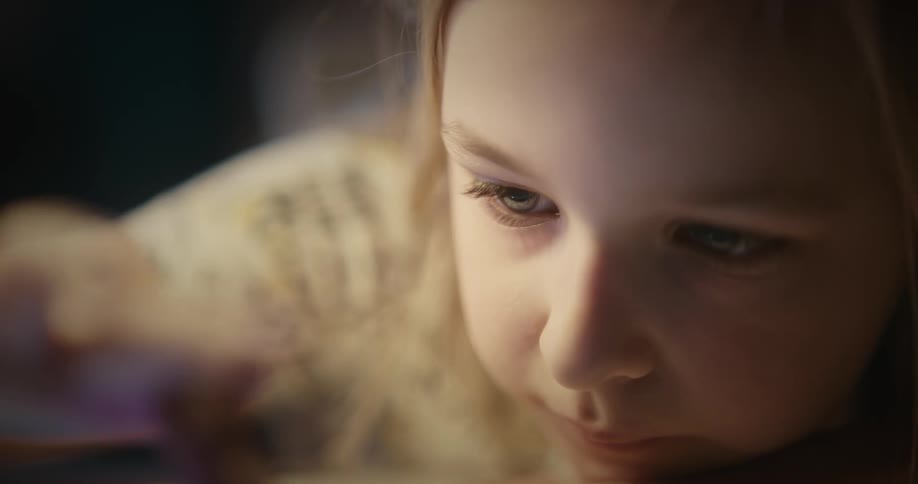 Close up of blonde girl using tablet in room