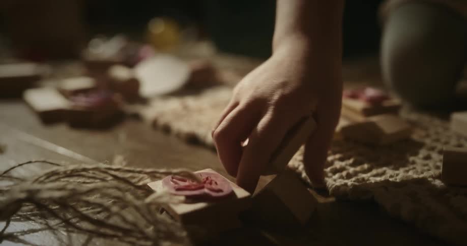 Blonde girl plays with blocks while kneeling on rug
