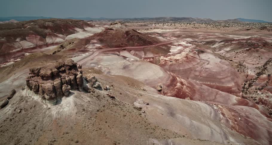 Dirt road cuts through arid terrain near wadi