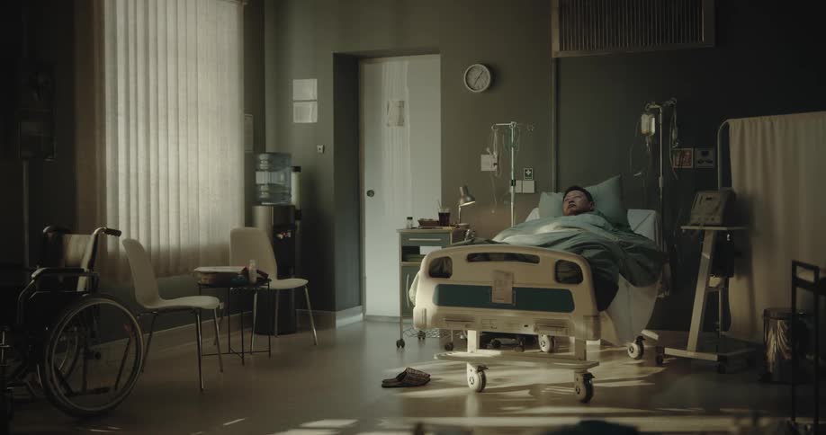 Man lying in a hospital bed sleeping