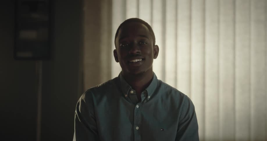 Portrait of a man giving a gentle smile in an indoor setting