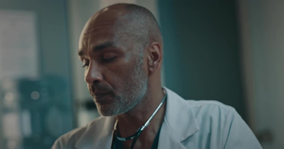 A doctor talking and shaking his head leaves a female patient looking fearful and sad