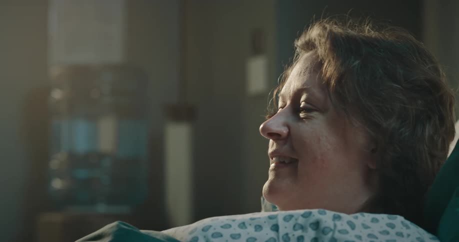 Doctor talking to a patient and then standing up