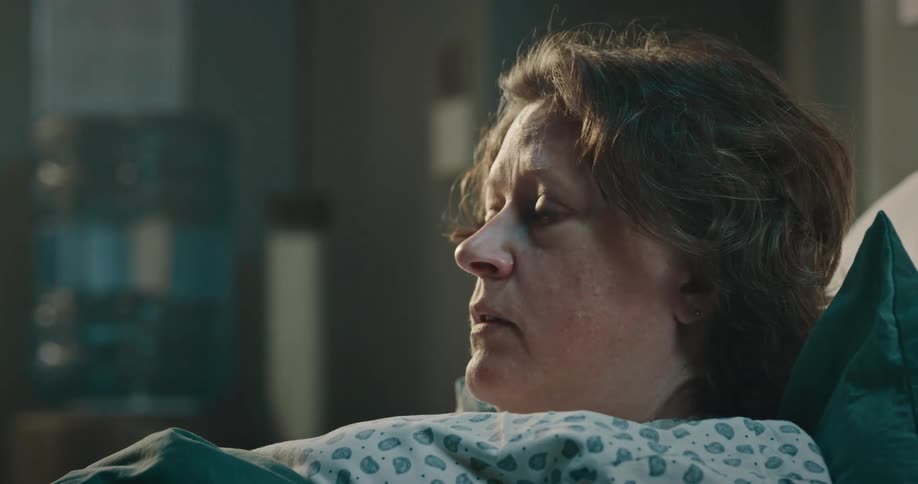 Doctor talking to a patient who is lying down
