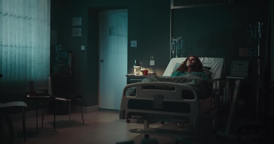 Woman lying in a hospital room deep in thought
