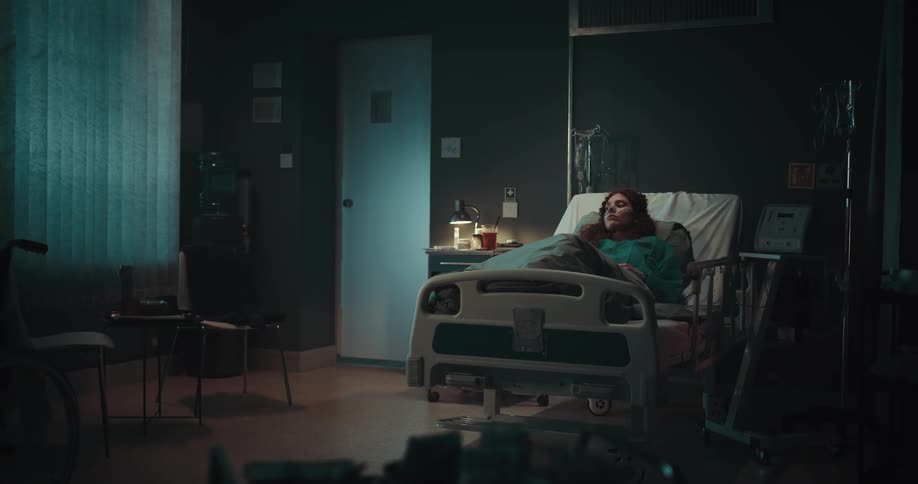 A sad patient lying in the hospital bed