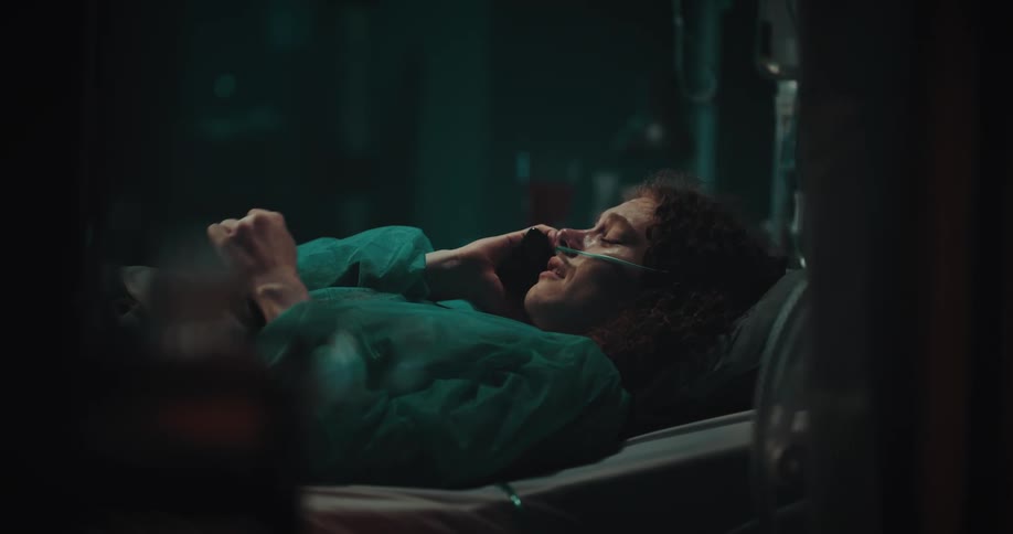 A woman is crying in the hospital as she talks on the phone