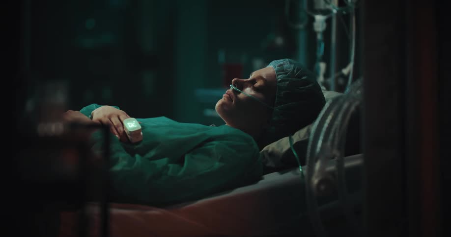 Lady sleeps on the hospital bed with surgery cloth and nasogastric tube on