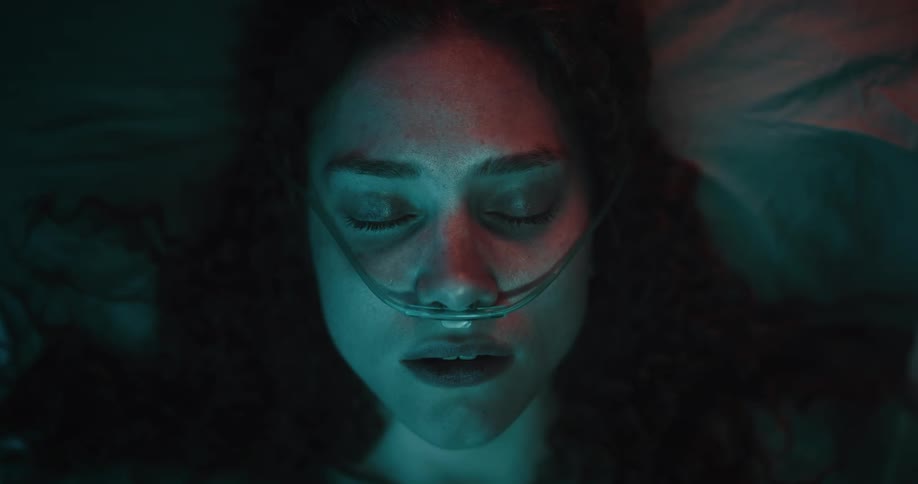 Portrait of a young woman waking up with medical equipment on her face