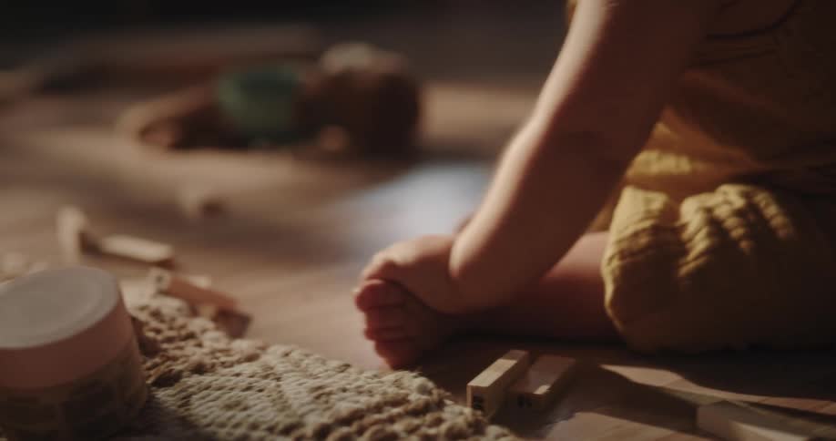 Baby girl sitting on the floor playing