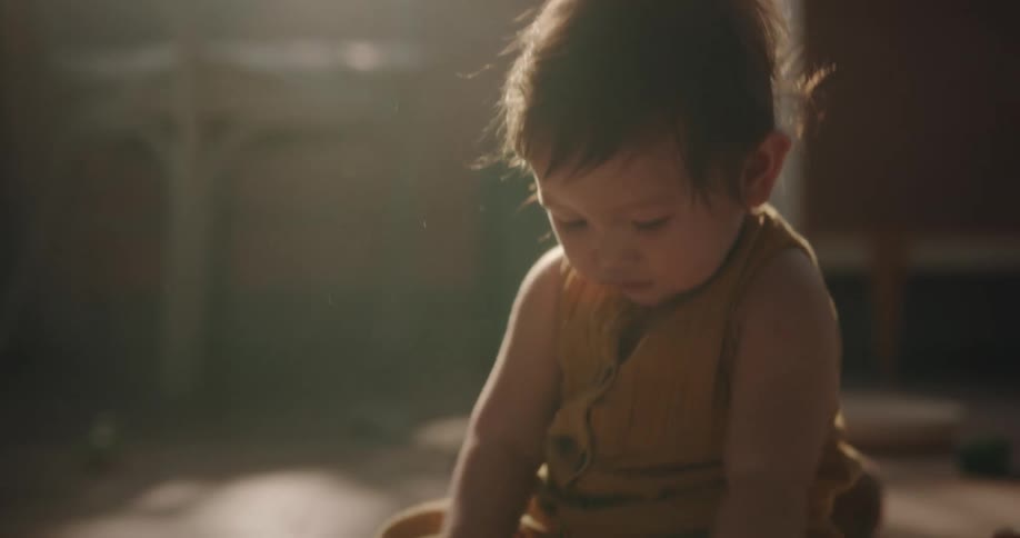 A child playing with toys on the floor indoor in the morning