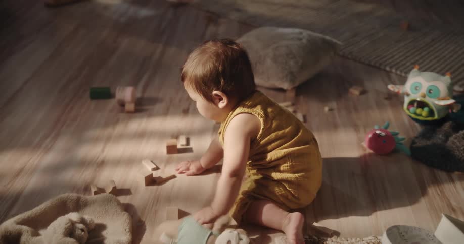 Baby playing on the floor with their hands