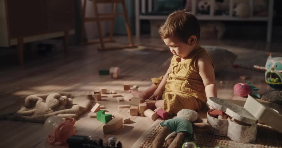 A baby playing with lots of toys in the living room