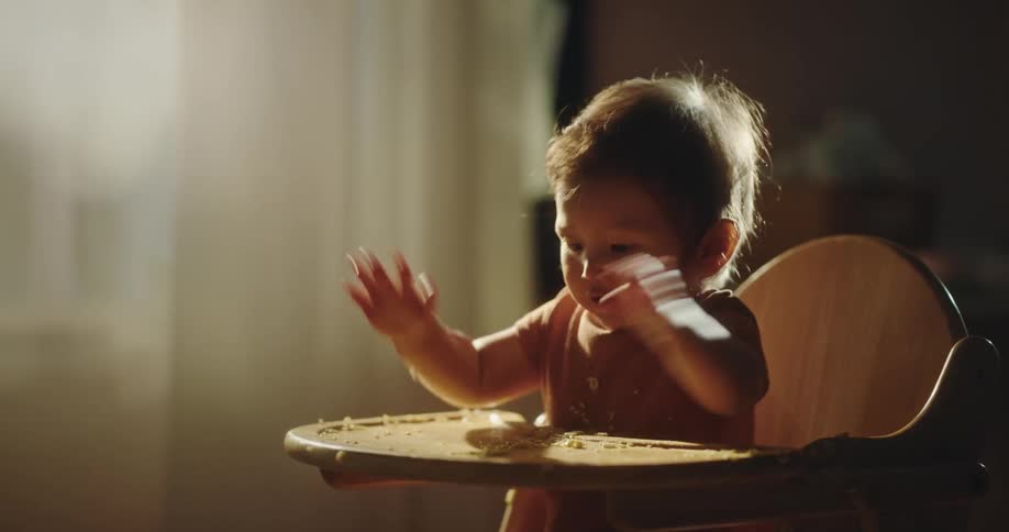 An infant playing the biscuits ruminants