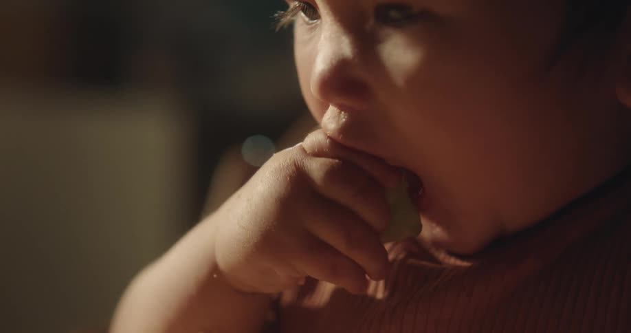 A baby is eating at home