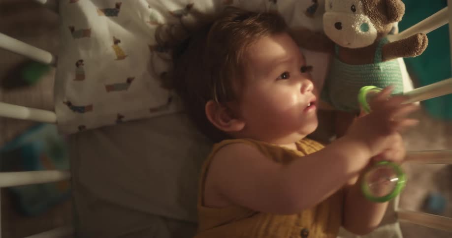A baby is moving around in the crib