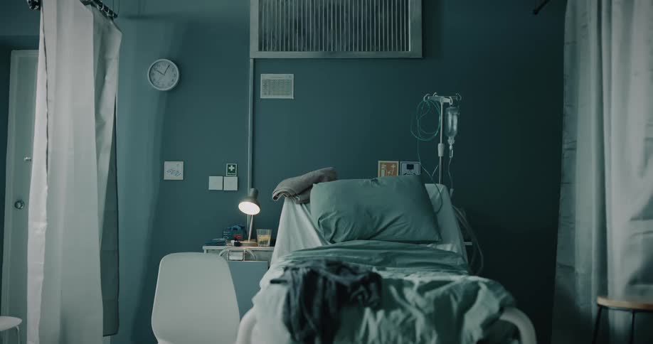 An empty and messy hospital bed