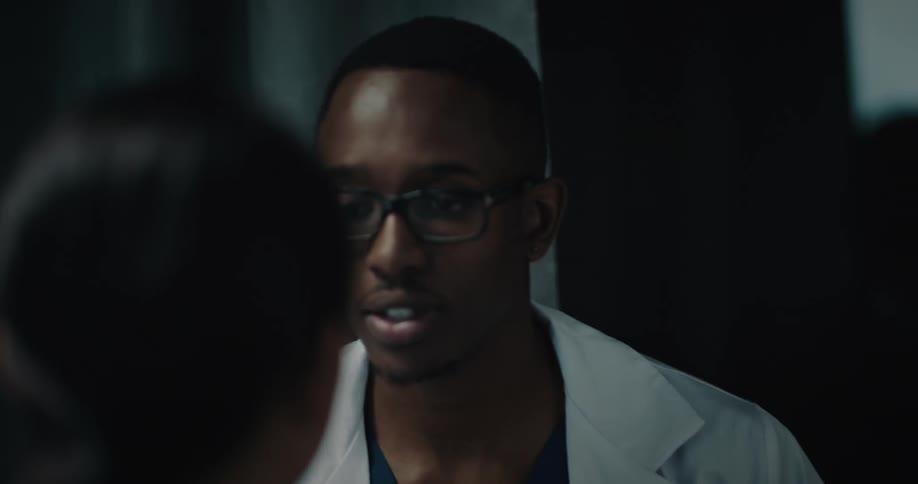 Male doctor palpating a womans neck