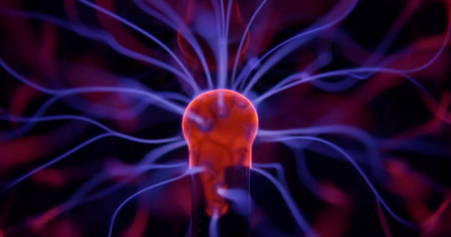Glowing purple wisps extend and waver into pink illuminated energy from a phosphorescent pink object