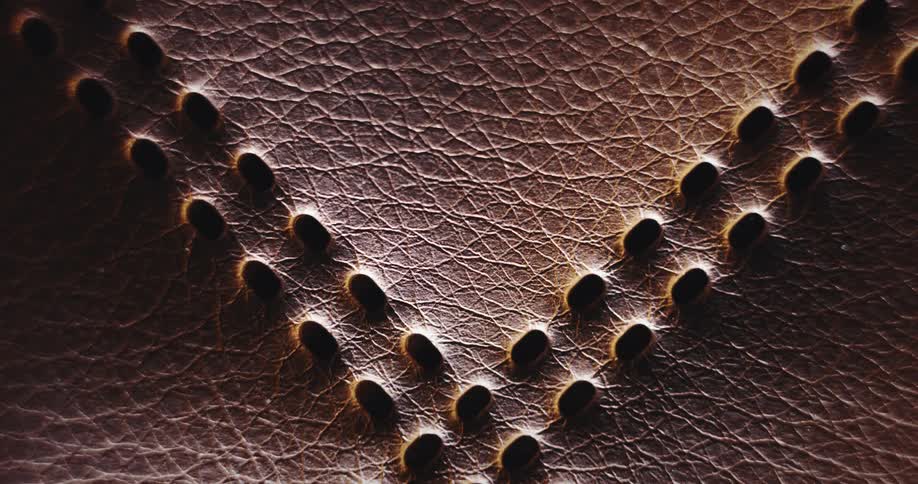 A leather texture with holes and glowing light