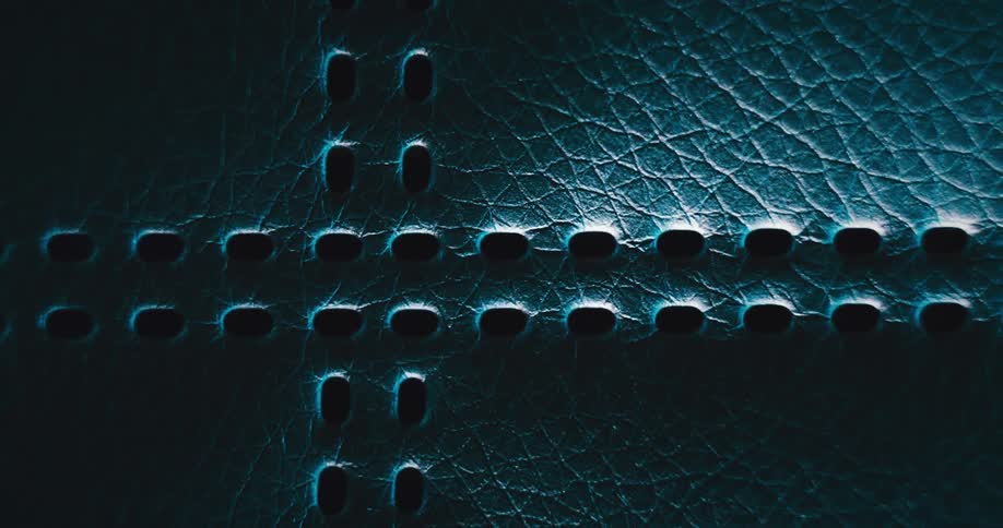 Parallel line of holes create cross on textured surface of object