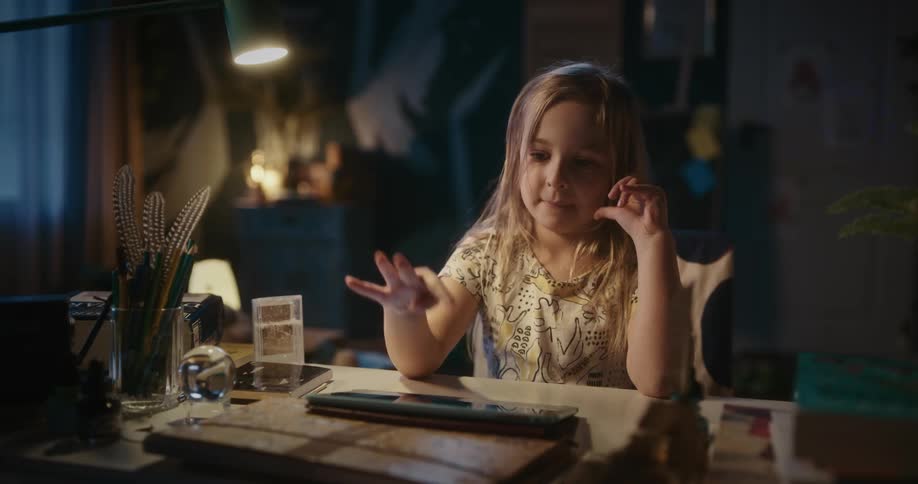 Young girl tapping on a tablet screen with her finger
