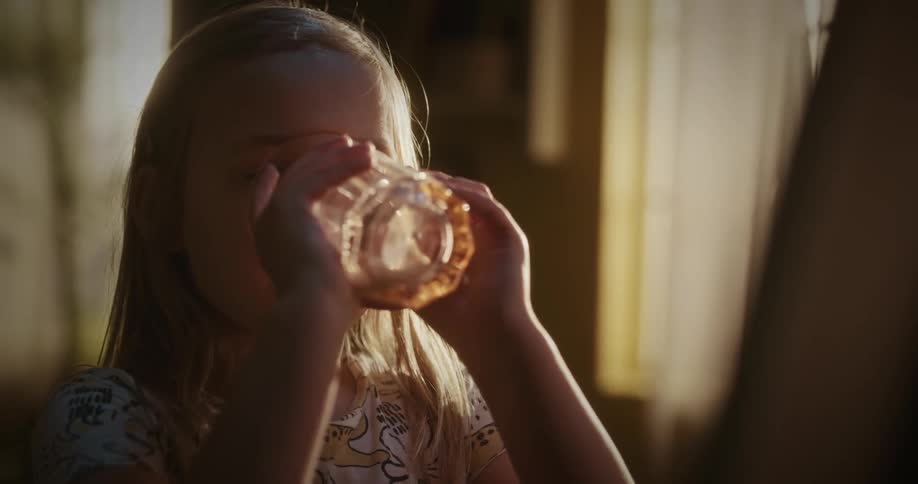Portrait of a girl drinking liquid from a glass