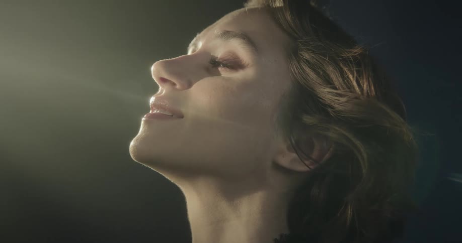 Portrait of a happy woman with lights reflecting on her face
