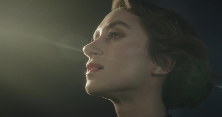 Close up of woman standing outdoors on windy night