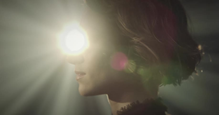 Portrait of a young woman with reflections of lights on her face