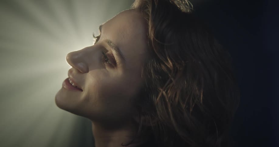 Closeup of a womans face with a reflection of light