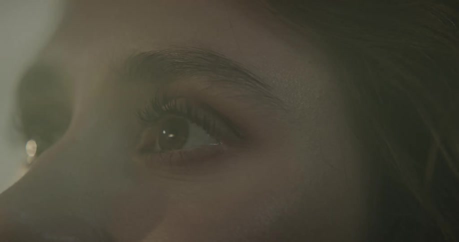 A woman is blinking her eyes