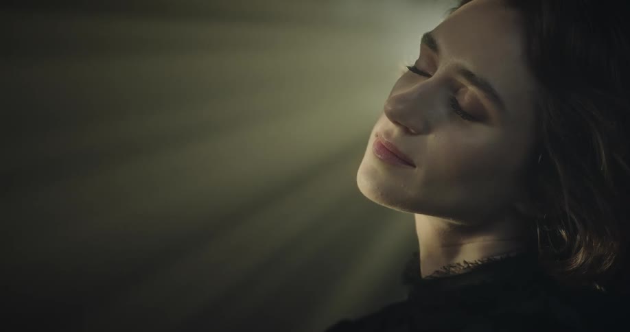 Close up of woman relaxing with her eyes closed at night