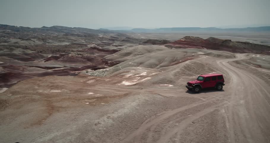 Jeep driving through mountains and natural hills