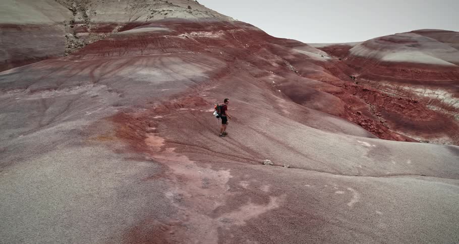 Skyline of a man walking in red mountains