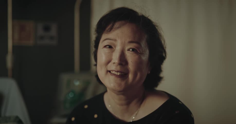 A smiling woman turns her head