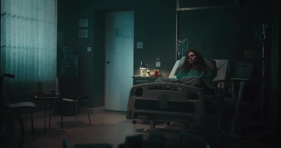 A patient lying in the hospital bed at night