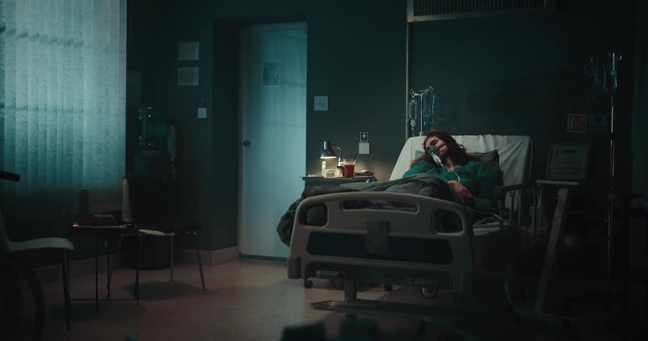 Woman lying on a hospital stretcher with medical devices feeling drowsy