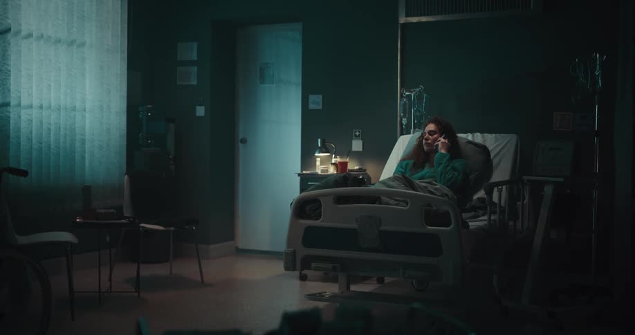 A patient in the hospital bed talking on her cell phone