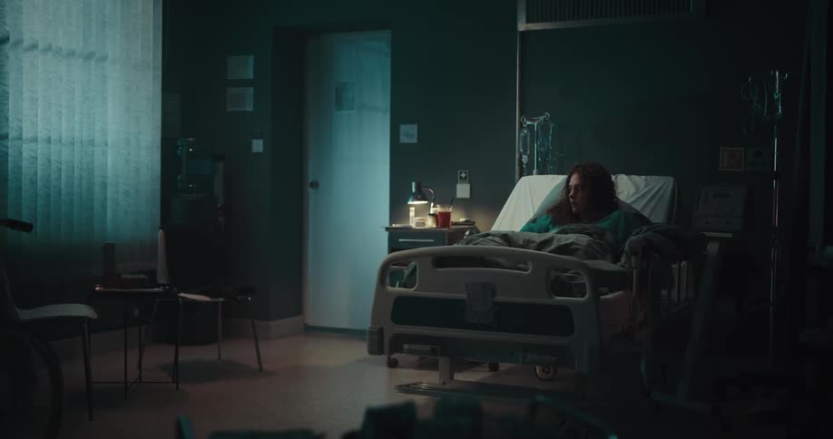 A girl waking up from a nightmare in a hospital room