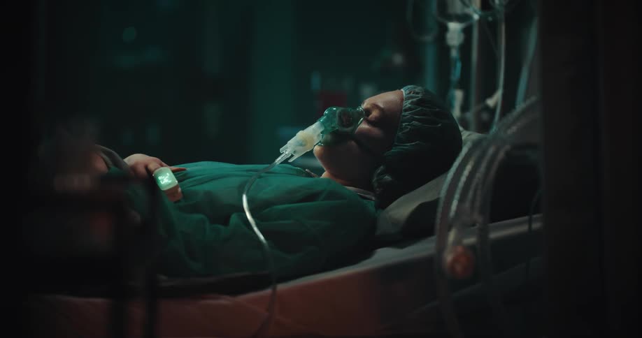 Woman sleeping on a hospital bed with medical equipment